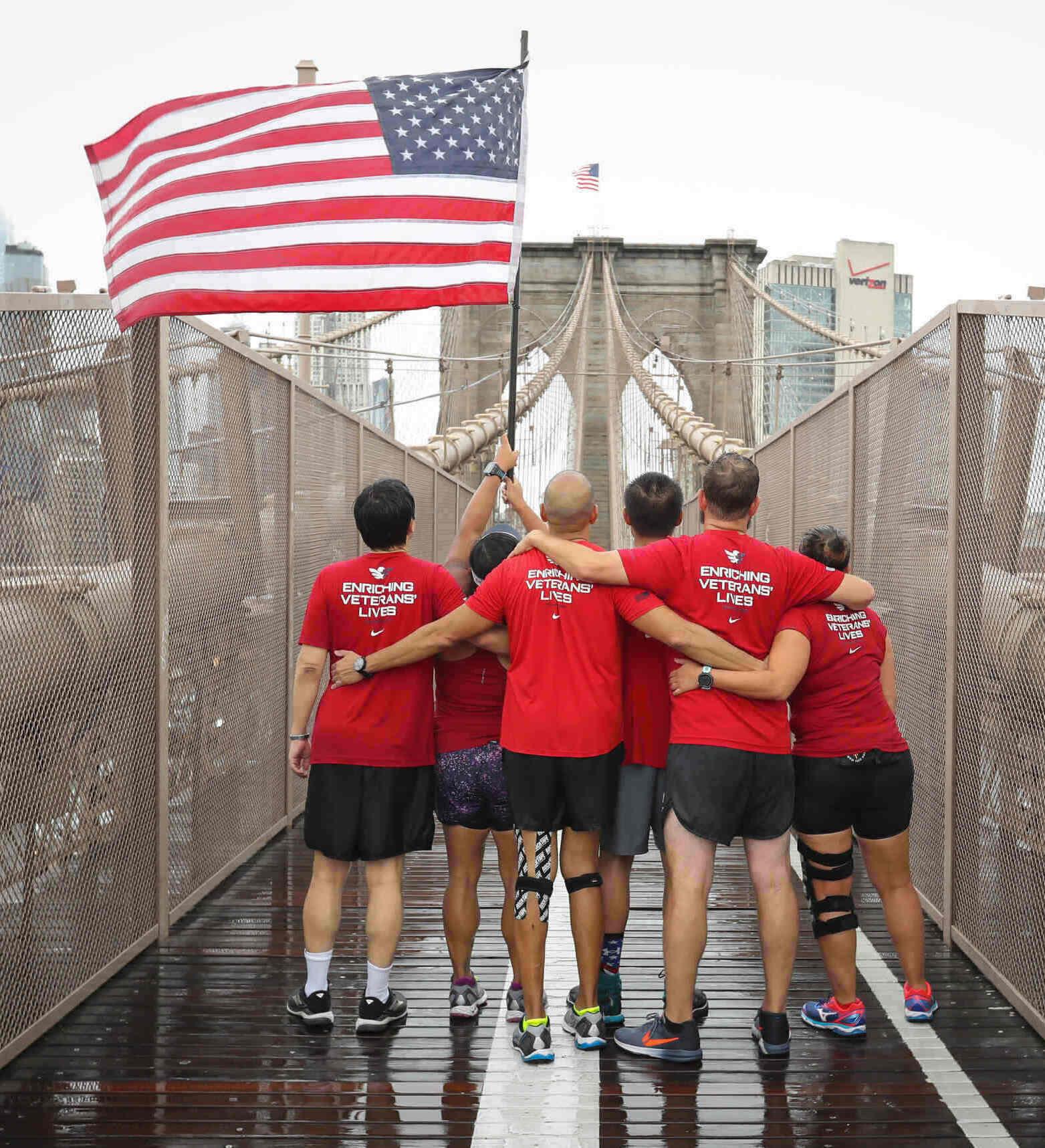 Veterans standing with flag